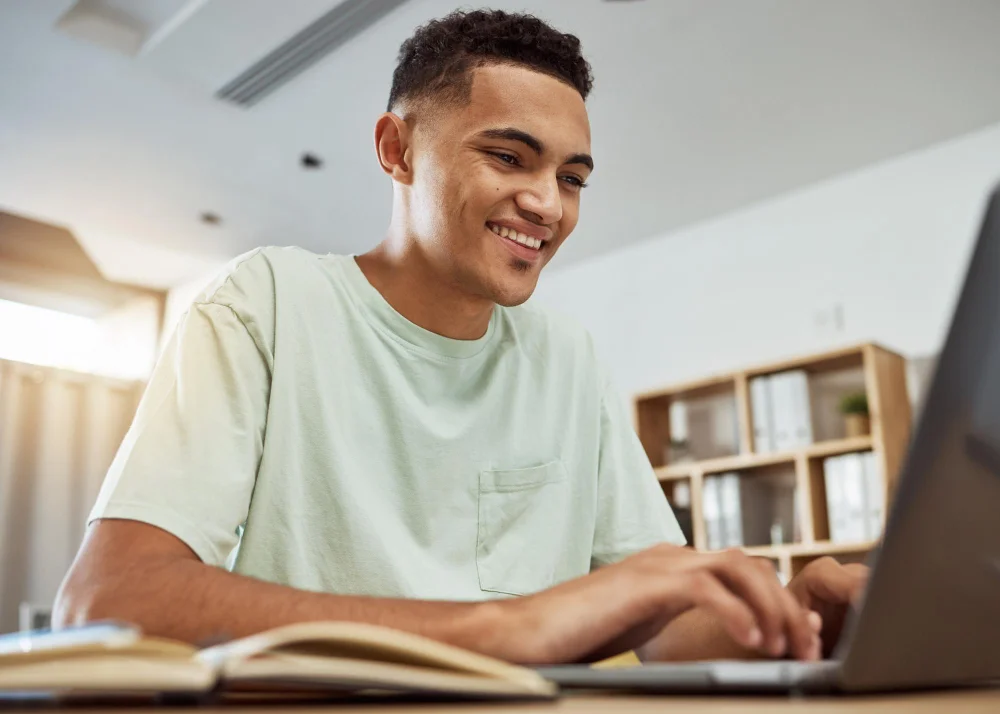Estudante pesquisa no notebook as regras e a nota de corte do Prouni para Medicina